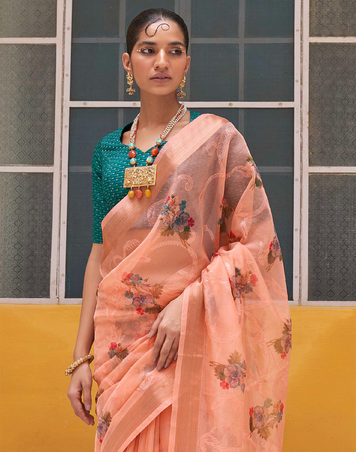 Collection of Peach Organza Floral Print Saree With Tussels and Contrasting Blue Blouse in a gallery layout