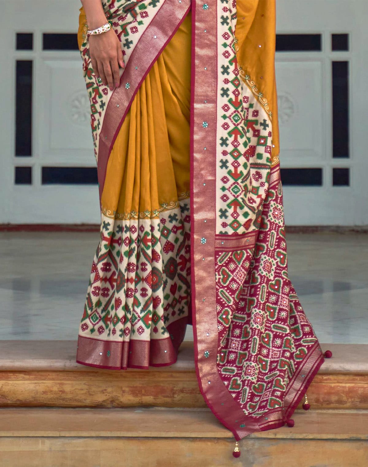 Collection of Mustard and Maroon Mirror work Patola Silk Saree in a gallery layout