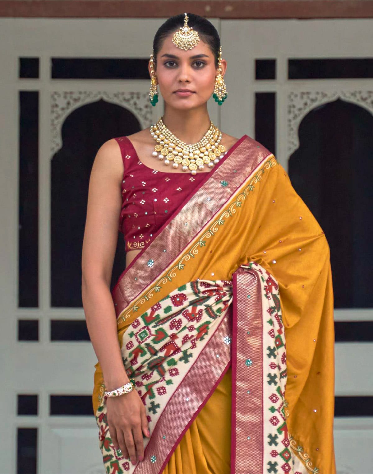 Collection of Mustard and Maroon Mirror work Patola Silk Saree in a gallery layout