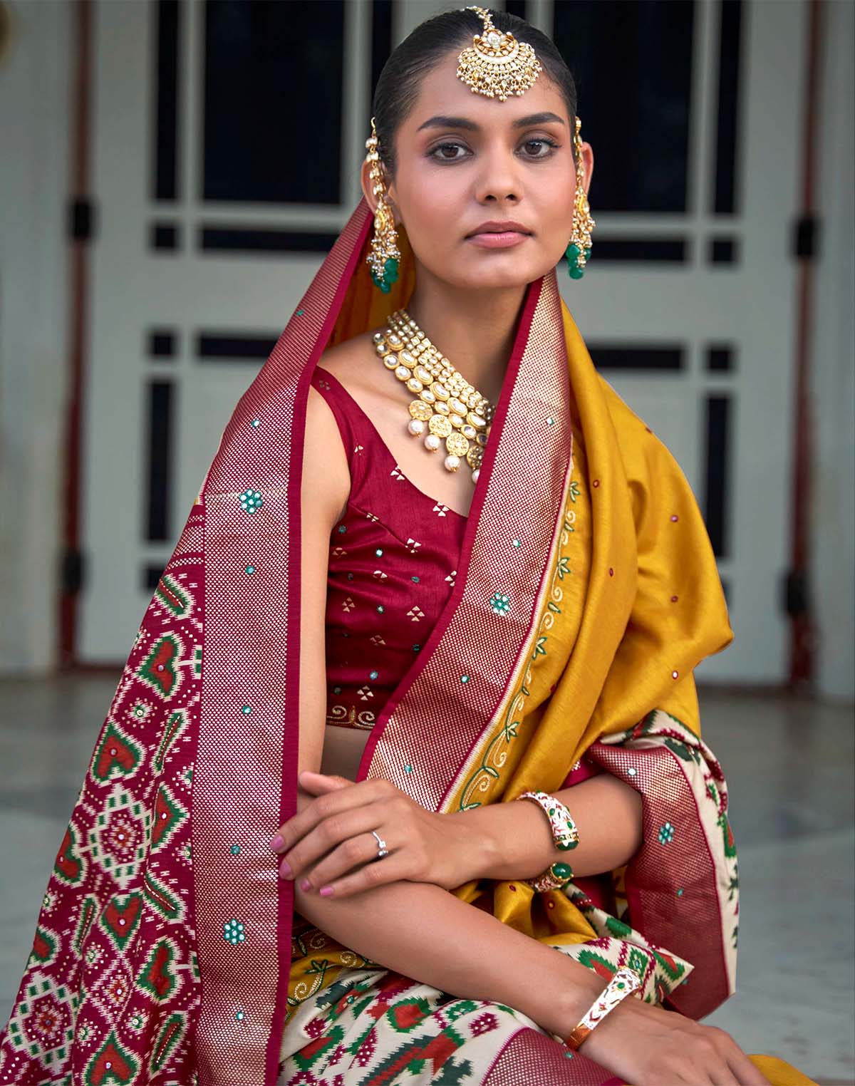 Collection of Mustard and Maroon Mirror work Patola Silk Saree in a gallery layout