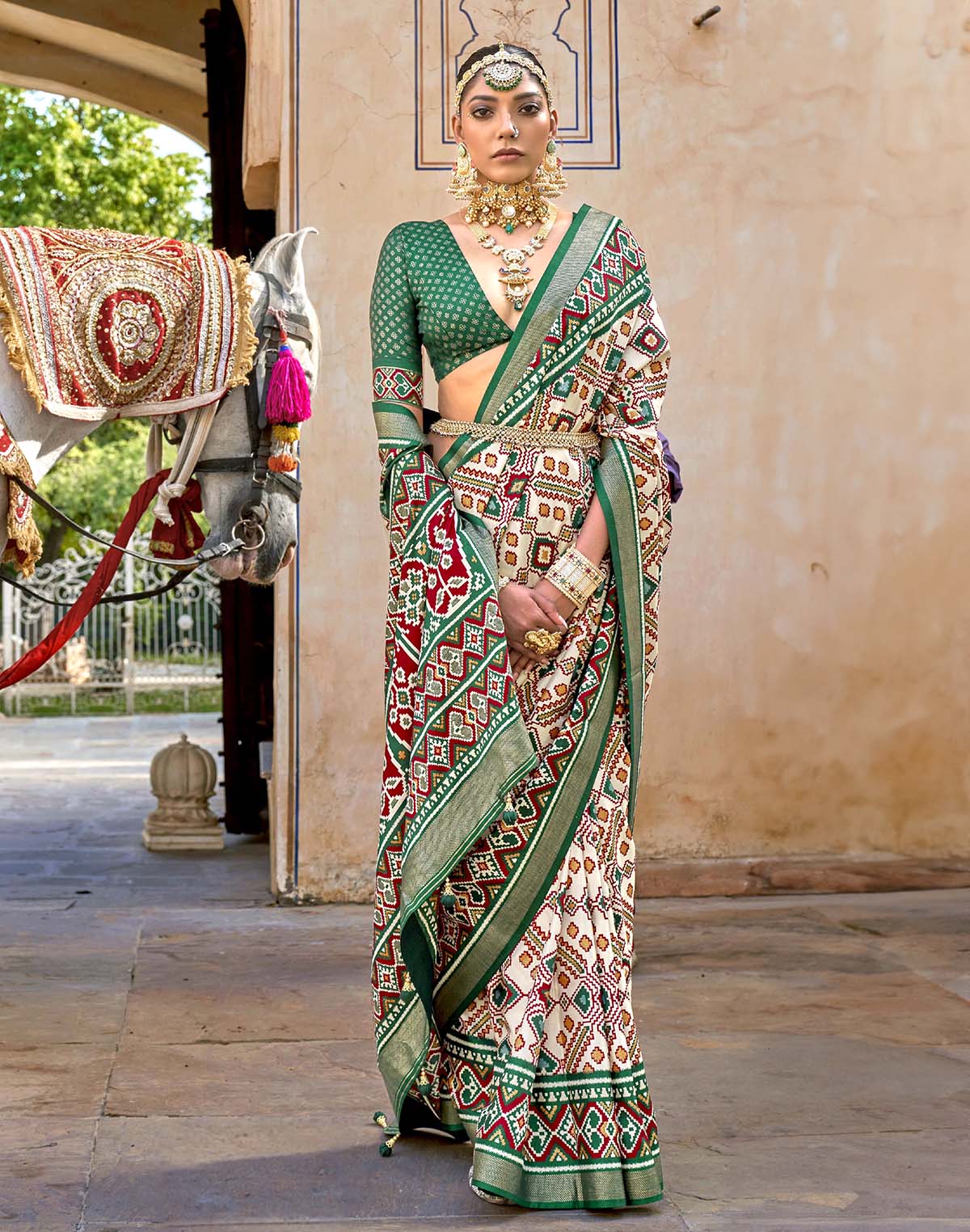 Collection of Green Ikat Patola Silk Saree with Unstitched Blouse in a gallery layout