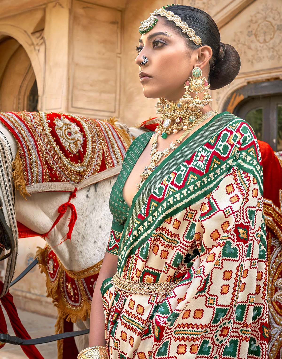 Collection of Green Ikat Patola Silk Saree with Unstitched Blouse in a gallery layout