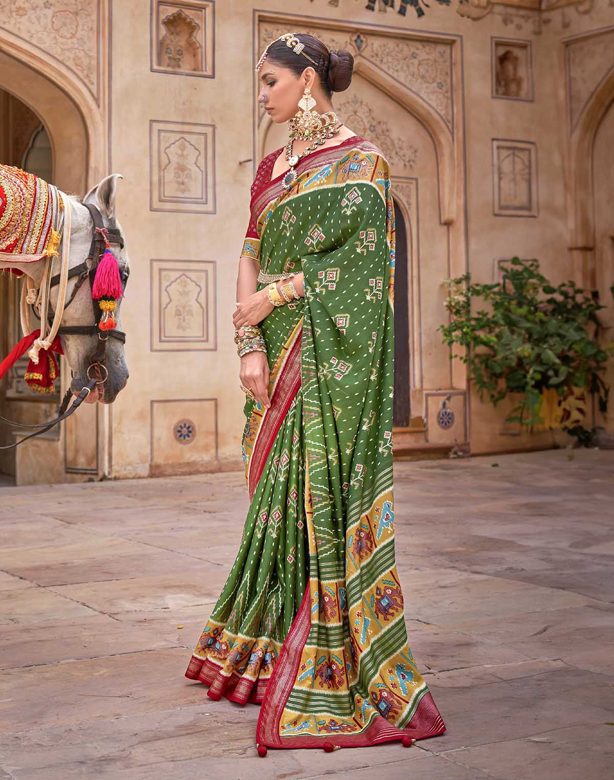 Collection of Dark Green smooth fabric Patola Saree in a gallery layout