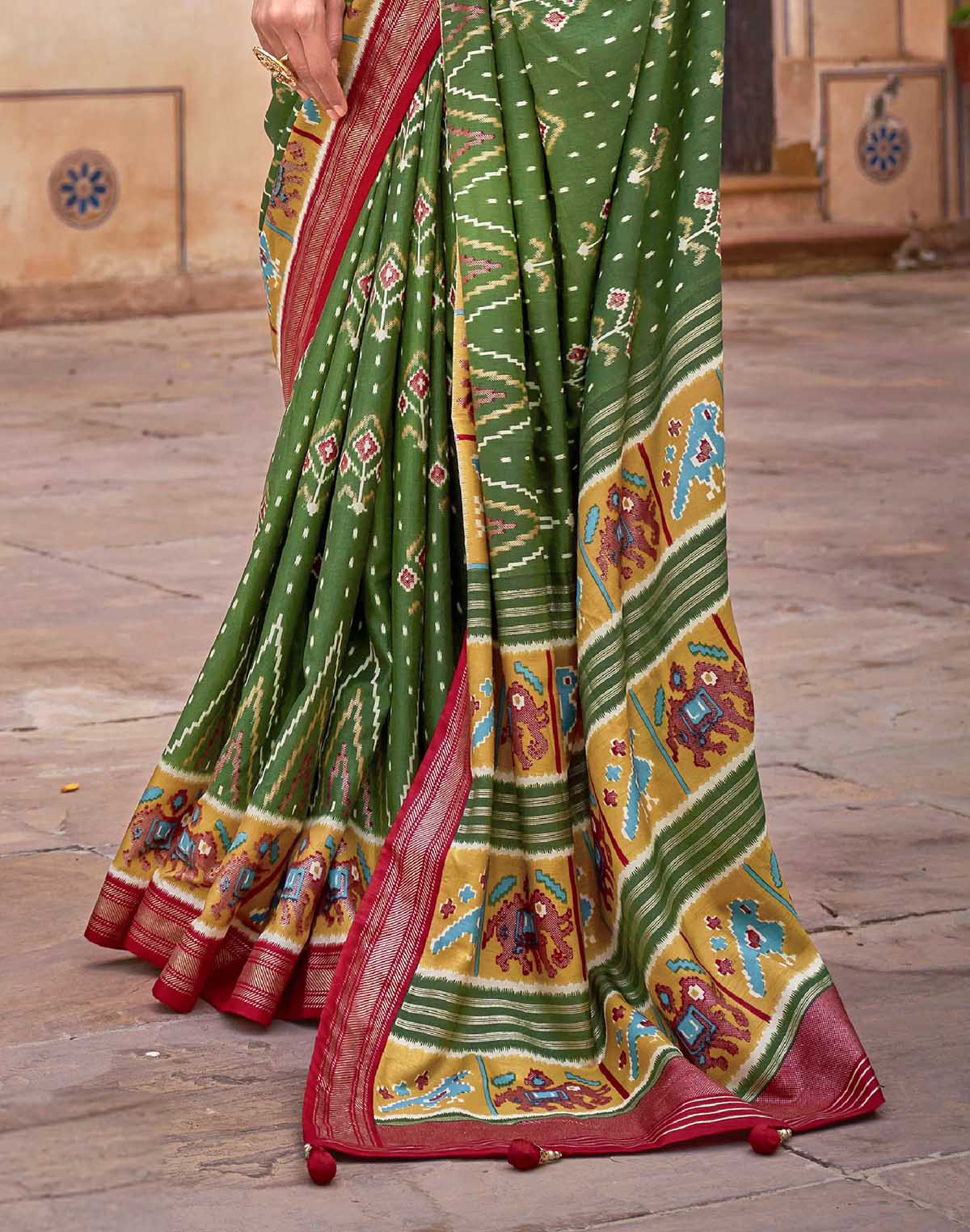 Collection of Dark Green smooth fabric Patola Saree in a gallery layout