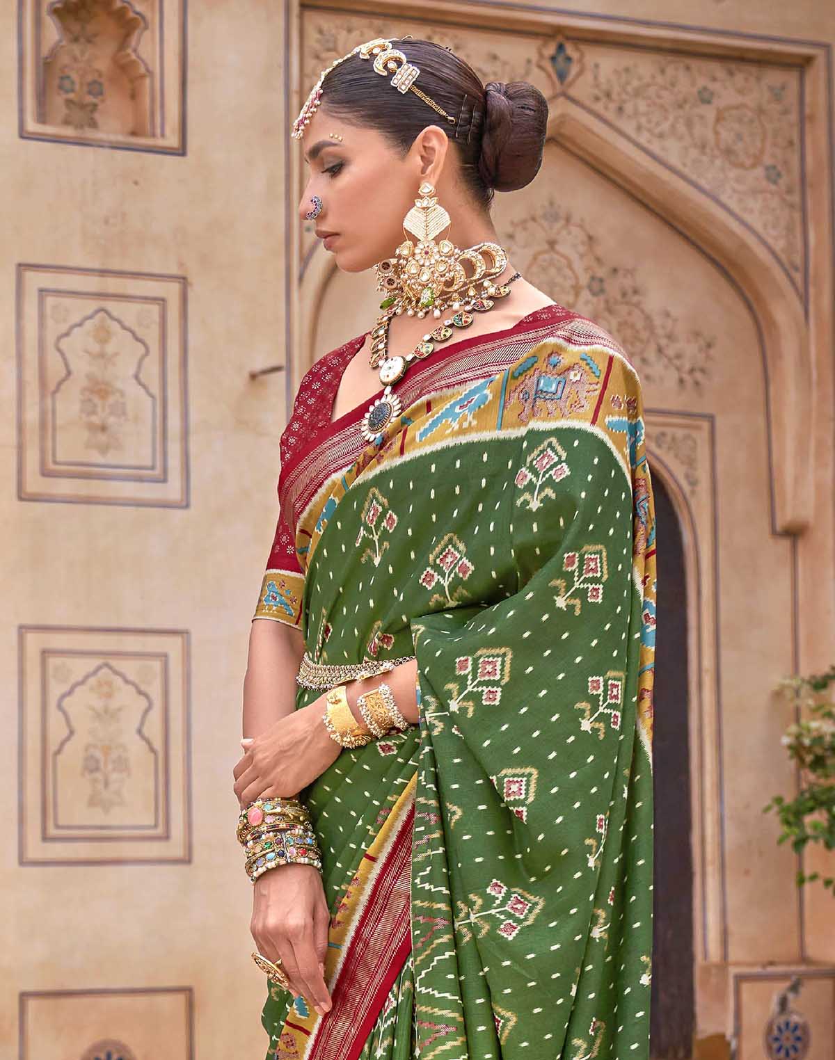 Collection of Dark Green smooth fabric Patola Saree in a gallery layout