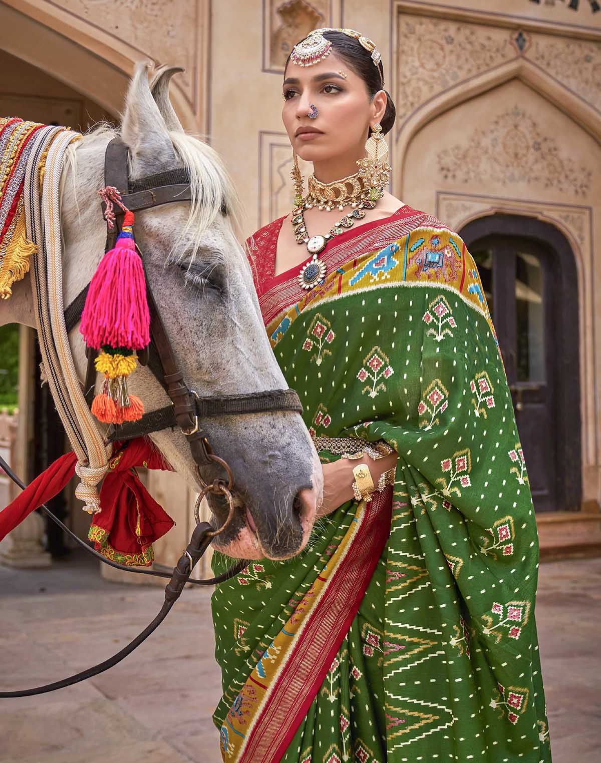 Collection of Dark Green smooth fabric Patola Saree in a gallery layout