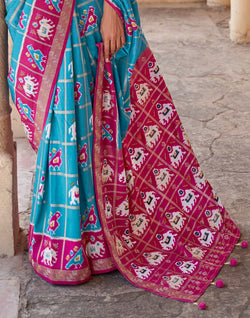 Collection of Sky Blue Designer Patola Silk Saree in a gallery layout