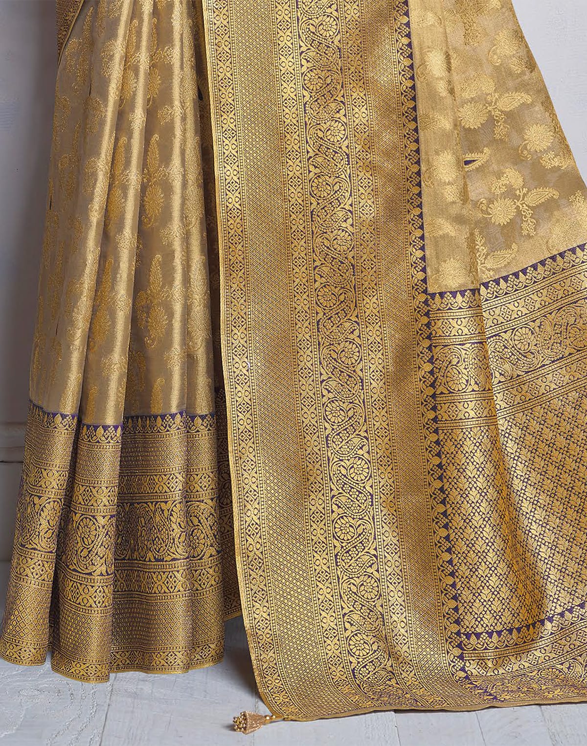 Collection of Gold Coloured all over Paisely design Banaras Tissue Saree in a gallery layout