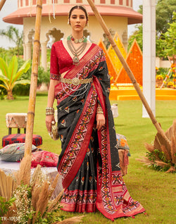 Collection of Alluring Black Patola Silk Floral Print Saree in a gallery layout