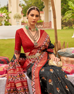 Collection of Alluring Black Patola Silk Floral Print Saree in a gallery layout