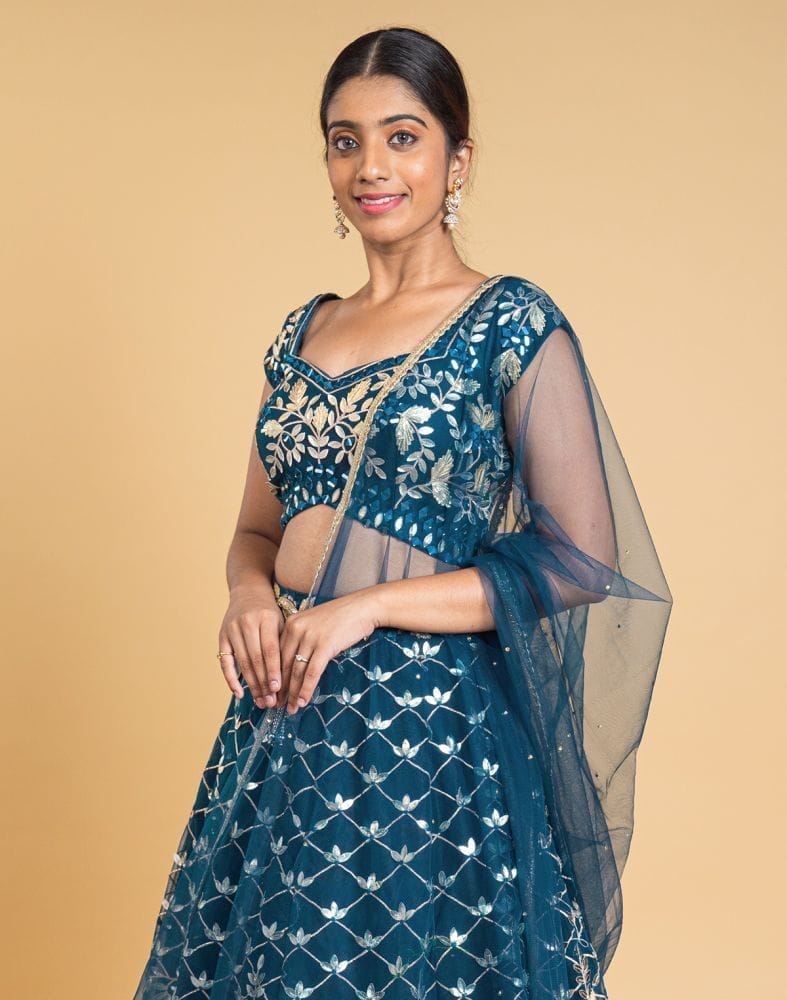 Collection of Designer Peacock Blue Floral Netted gotta patti Crop Top and lehenga set in a gallery layout