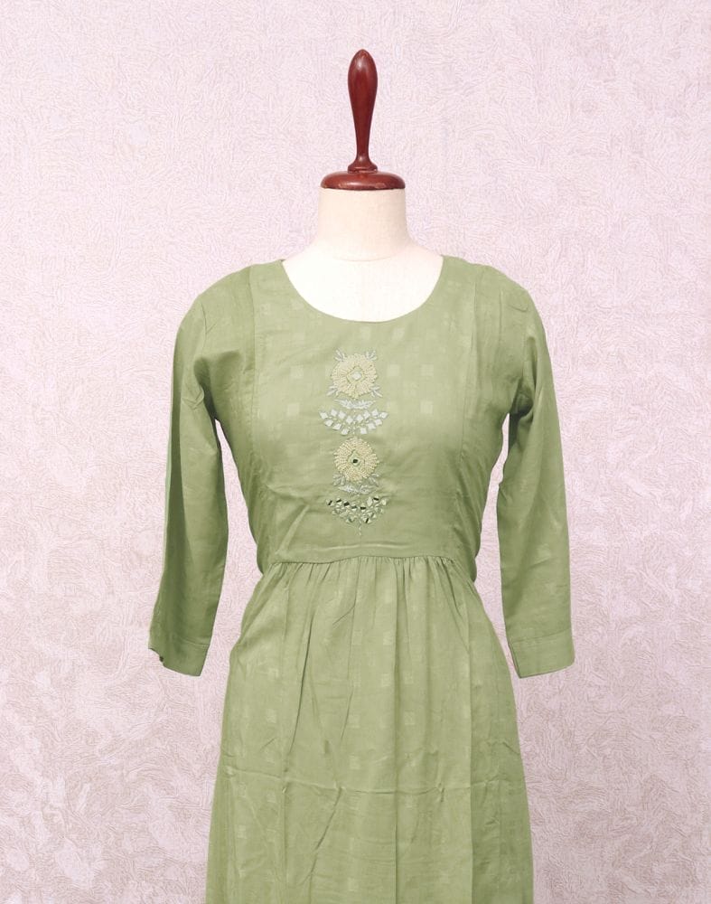 Collection of Light Green Geometric Cotton Silk Mirror work Kurti in a gallery layout