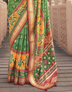 Collection of Green Ikat Pattern Mirror work Patola Saree in a gallery layout