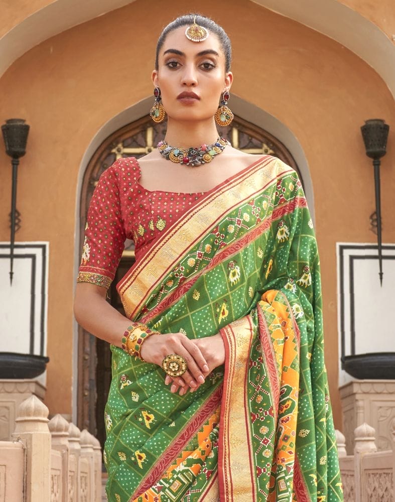 Collection of Green Ikat Pattern Mirror work Patola Saree in a gallery layout