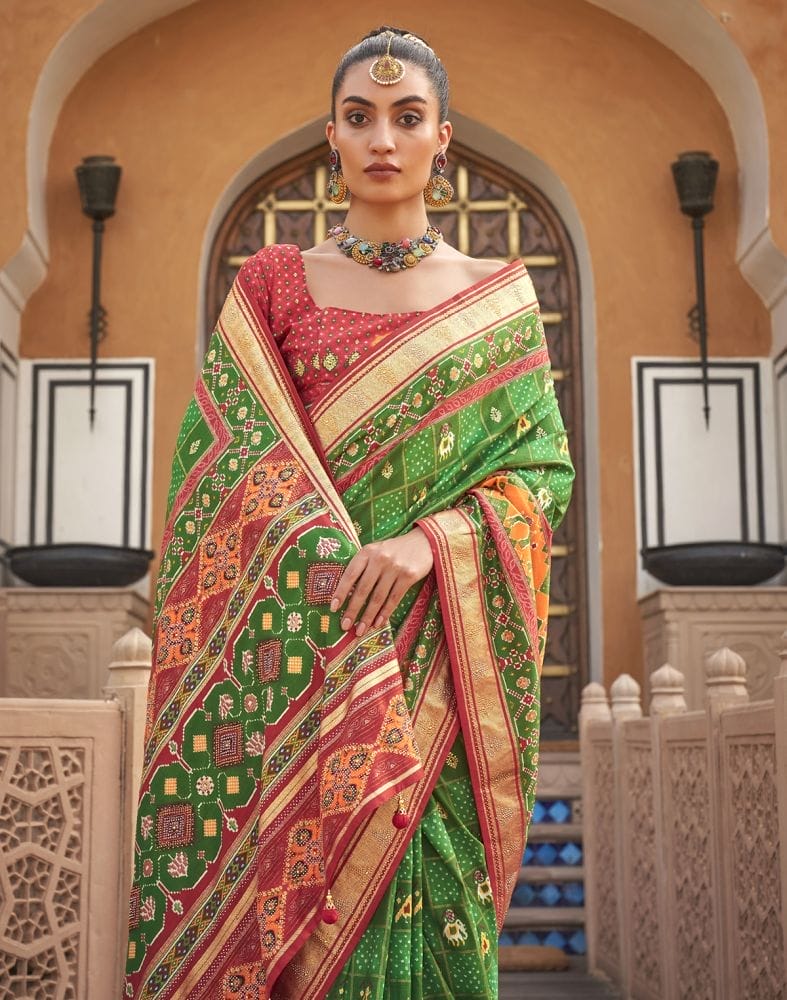 Collection of Green Ikat Pattern Mirror work Patola Saree in a gallery layout