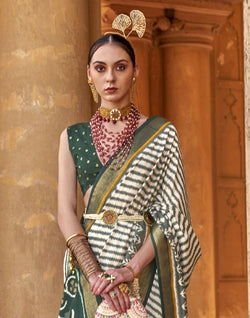 Collection of Off White Stripes Pattern Patola Fabric Saree in a gallery layout